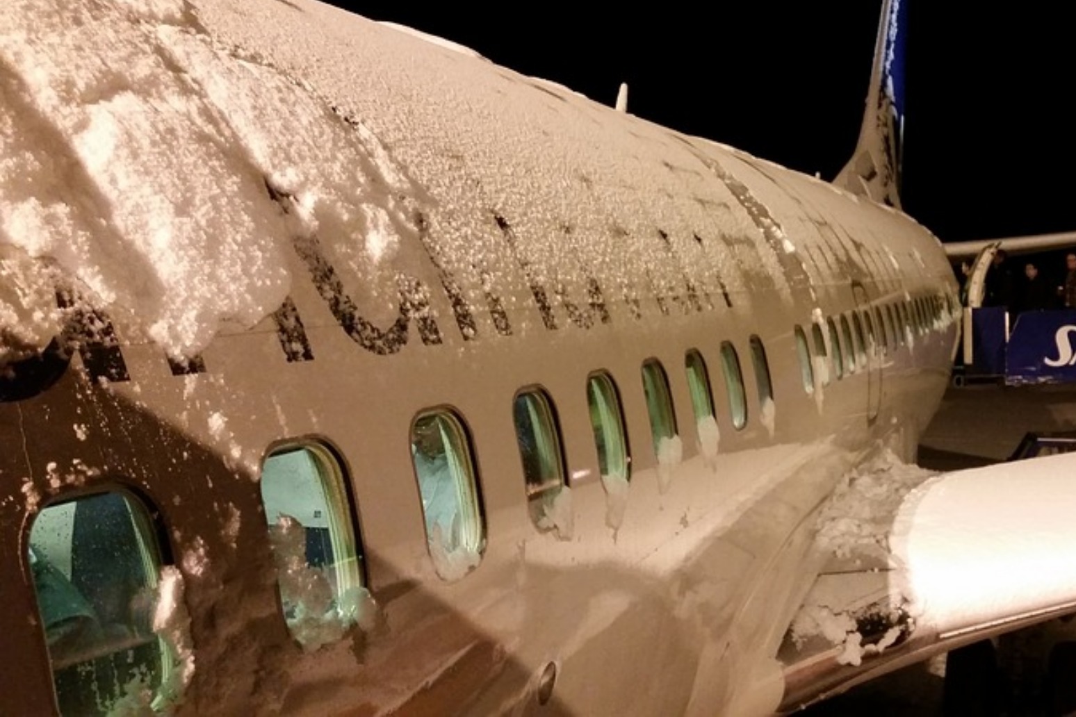 Snow causes widespread disruption across parts of the UK with flights grounded 